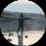 Tetimonial Duck hunter standing in shallow water aiming at birds during golden hour